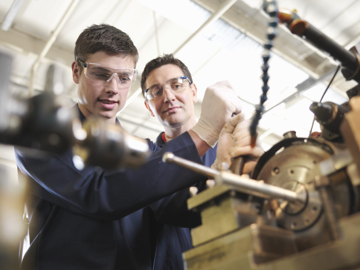 Experienced Engineer Teaching Apprentice