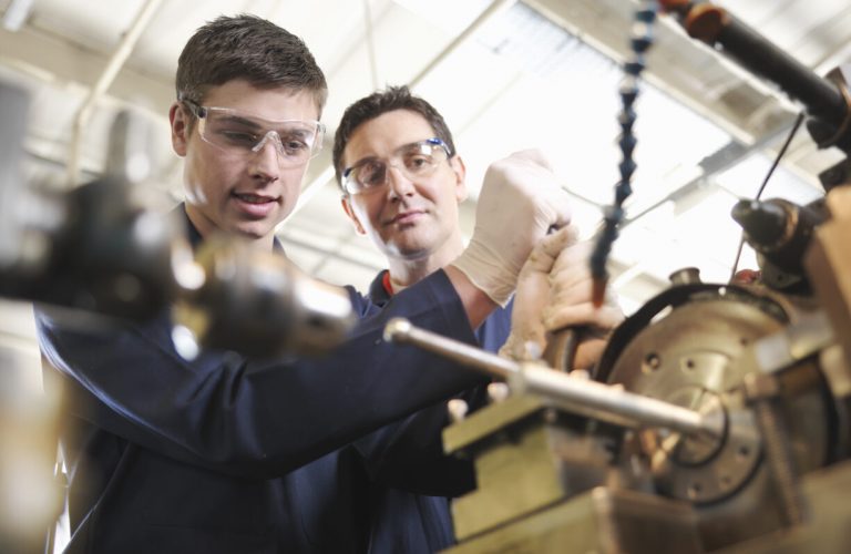 Experienced Engineer Teaching Apprentice